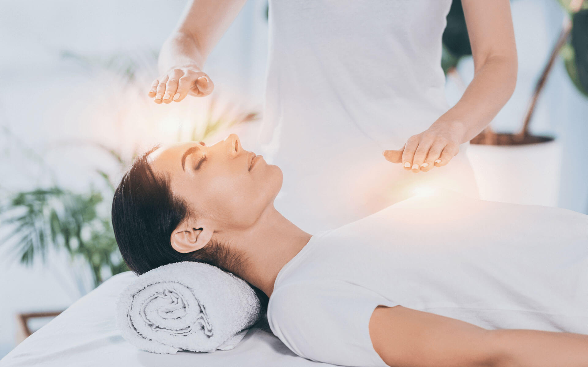 Woman lying on a massage table receiving a reiki treatment
