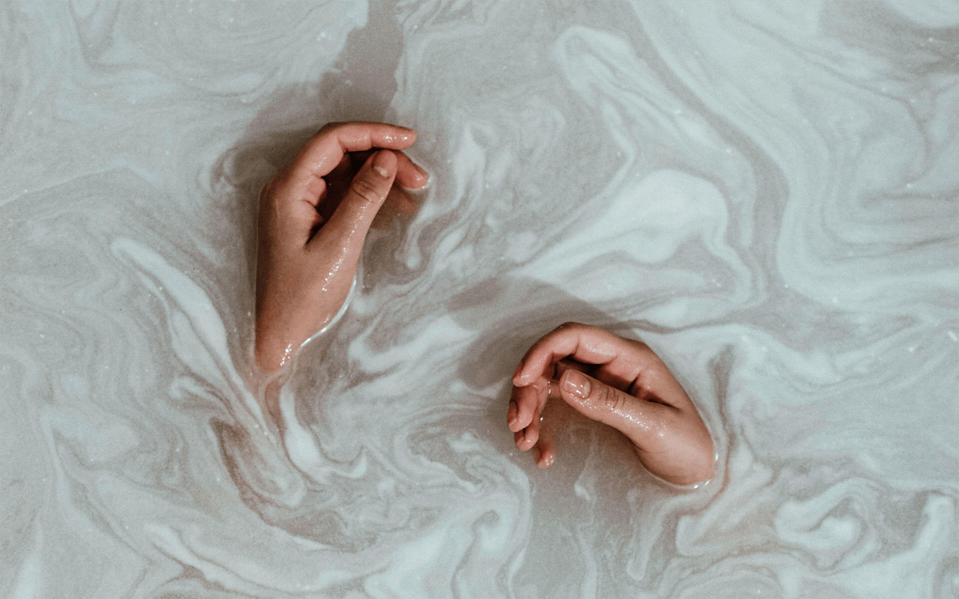 Two hands relaxing in water