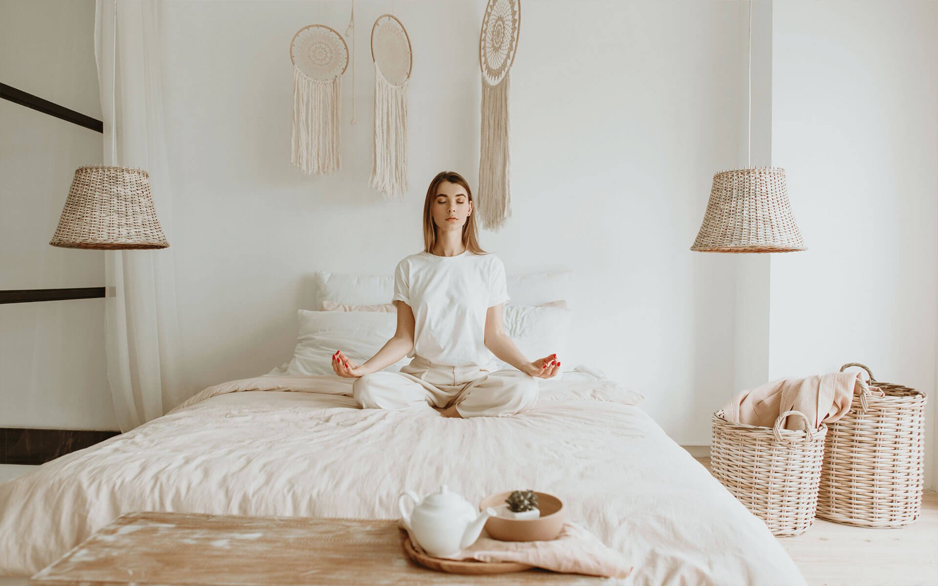 young woman doing her healing work and meditating on her bed