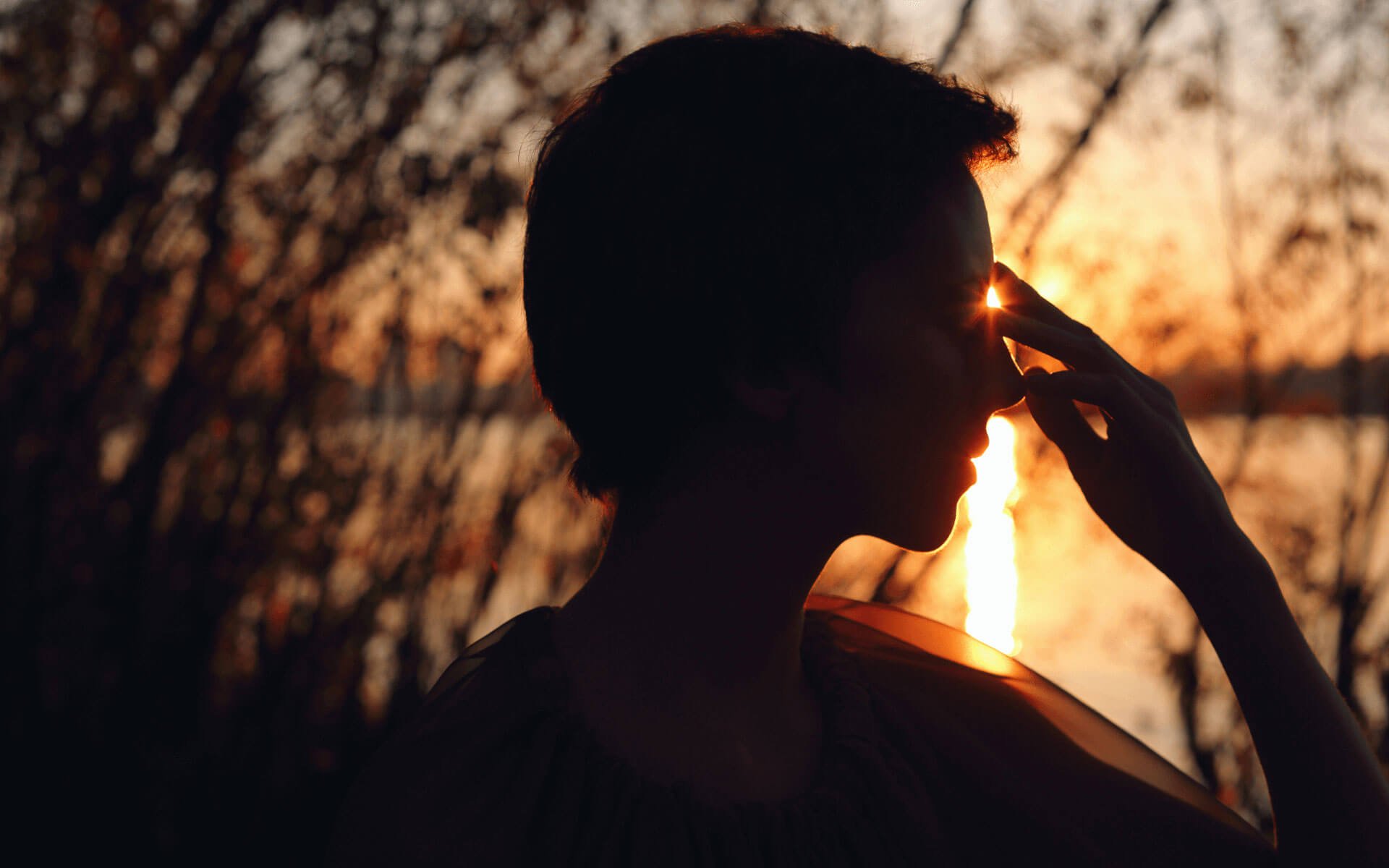 Woman touching her third eye at sunset, setting intentions